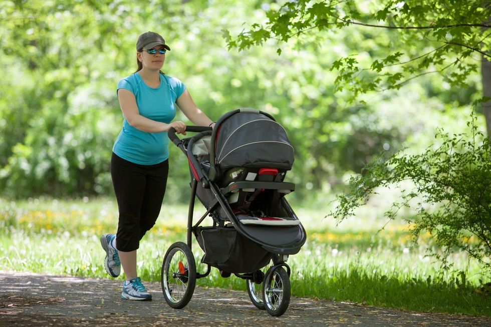 mother push baby stroller in park