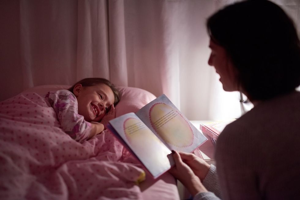 mother reading bedtime story to girl