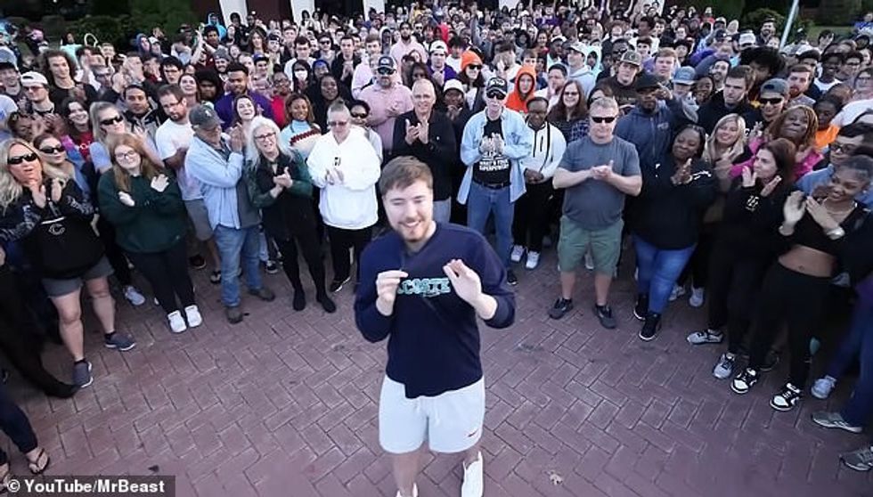 MrBeast stands with a crowd of his people whose vision he helped cure in his latest video