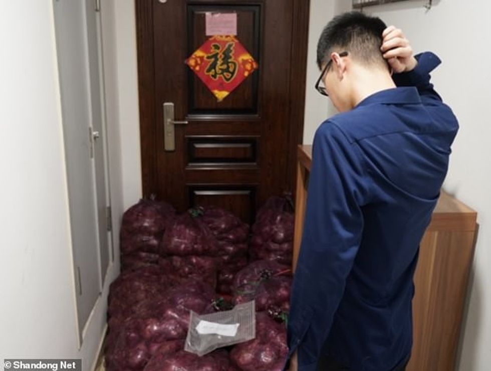Ms Zhao’s ex-boyfriend (pictured) later told Shandong Net that he broke up with the Chinese woman due to her ‘crazy behaviours’. He is seen standing at his front door piled with bags of onions on Saturday