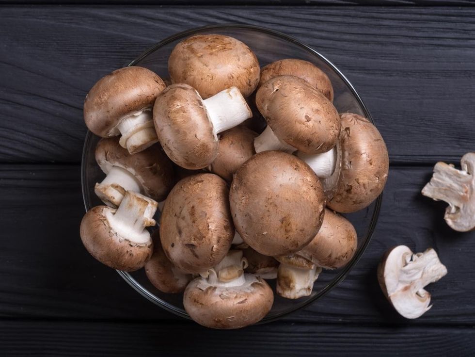 mushrooms in a bowel on a dark table
