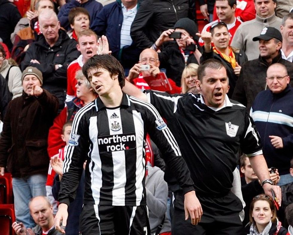 Newcastle's Joey Barton, left, reacts after being sent off by referee Phil Dowd, right, for a tackle on Liverpool's Xabi Alonso, unseen, during their English Premier League soccer match at Anfield Stadium, Liverpool, England, Sunday, May 3, 2009. (AP Photo/Paul Thomas) ** NO INTERNET/MOBILE USAGE WITHOUT FOOTBALL ASSOCIATION PREMIER LEAGUE (FAPL) LICENCE. CALL +44 (0) 20 7864 9121 or EMAIL info@football-dataco.com FOR DETAILS **