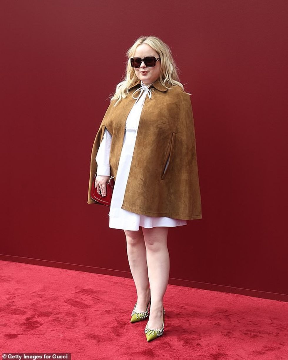 Nicola Coughlan exuded elegance in a white bow-tie mini dress, teamed with a brown suede poncho jacket