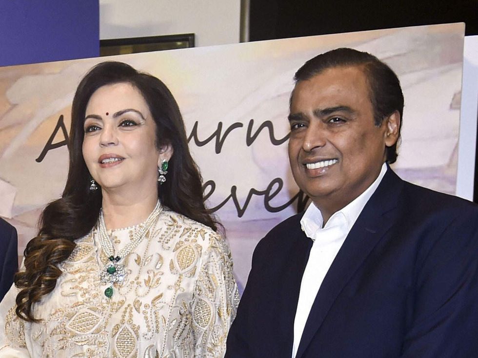 nita ambani opted for an ivory gold ensemble and mukesh ambani looked sharp in a tailored suit