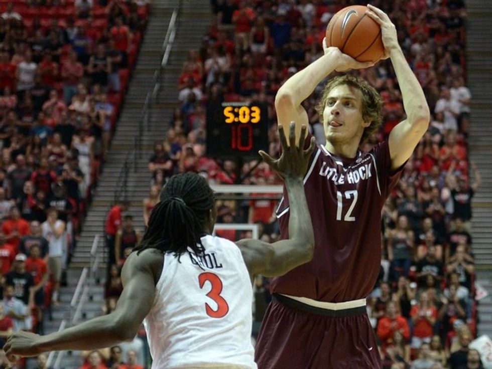 Nov 21, 2015; San Diego, CA, USA; Arkansas Little Rock Trojans forward Lis Shoshi (12) shoots as San Diego State Aztecs forward Angelo Chol (3) defends during the first half at Viejas Arena at Aztec Bowl. Mandatory Credit: Jake Roth-USA TODAY Sports