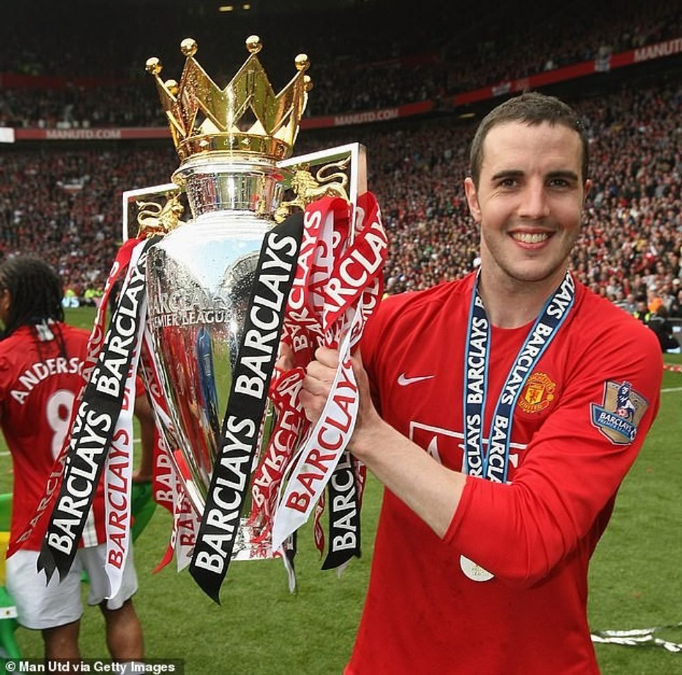 O'Shea celebrates with the Premier League trophy after United's title success in 2008-09