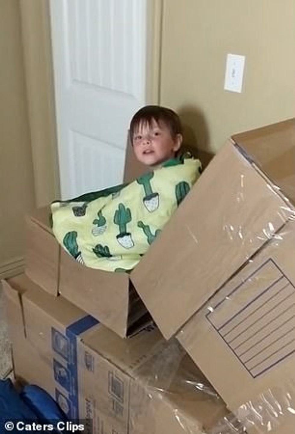 Parker Woods's son sides in a sleeping bag down the slide