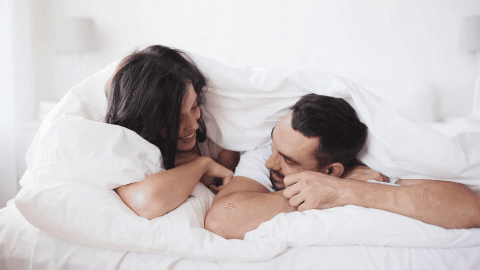 people rest love relationships and happiness concept happy couple lying in bed and having fun at home s7