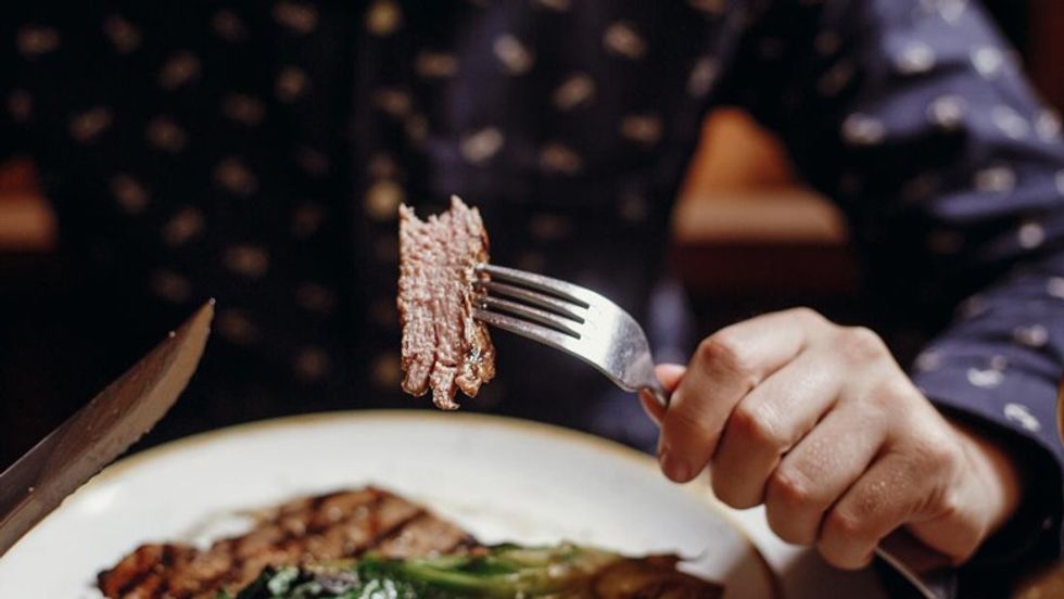 person eating steak or red meat