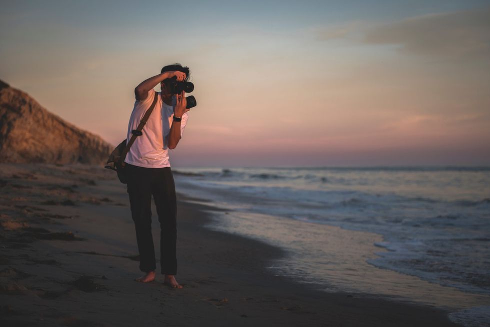 person taking photos on beach scaled 1