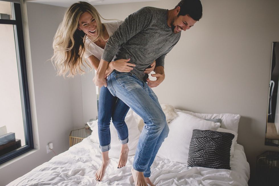photo of couple jumping on the bed by Tami Keehn