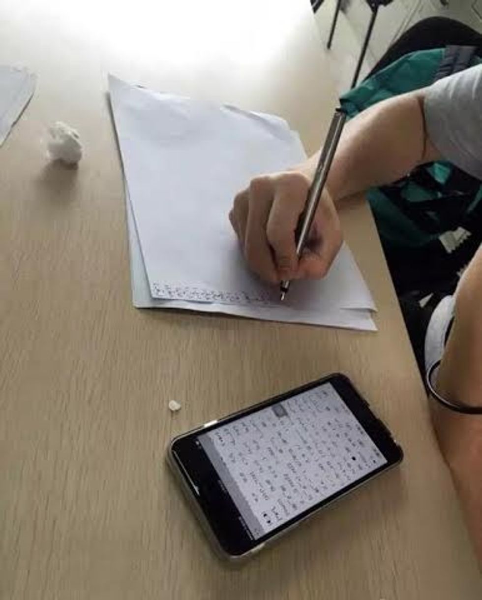 Pic shows: He is copying expressions.nnChinese students who arrive late for class are being asked to copy out 1,000 different emojis on a piece of A4 paper after a university instructor came up with the bizarre and ingenious new punishment.nnPictures of the reportedly