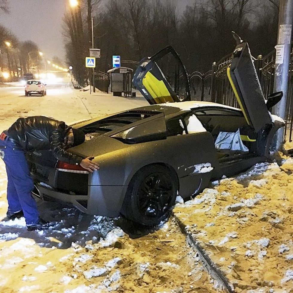 Pic shows: The Lamborghini after the accident. The owner is hugging the car. A driver who wrote off his Lamborghini sports car when he ploughed into a lamp post has been caught on camera giving it a goodbye hug. The man lost control on an icy road in the Russian capital city of Moscow and slammed head-on into the pole at speed. He later posted a photograph of himself hugging the boot of the badly damaged car and posted it on social media where he is known as ëaleksanyan500í. Aleksanyan seemed in good spirits despite ruining his expensive sports car. He admitted: