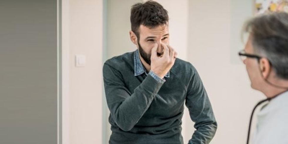 portrait man having sinuses examined 1255007807