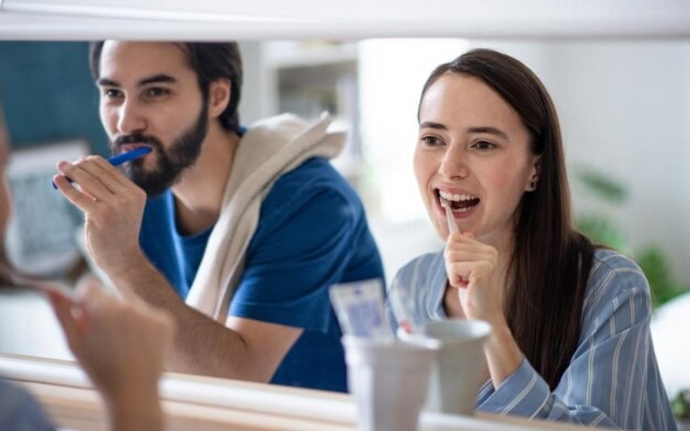 portrait young couple brushing teeth front mirror indoors home 535069 158