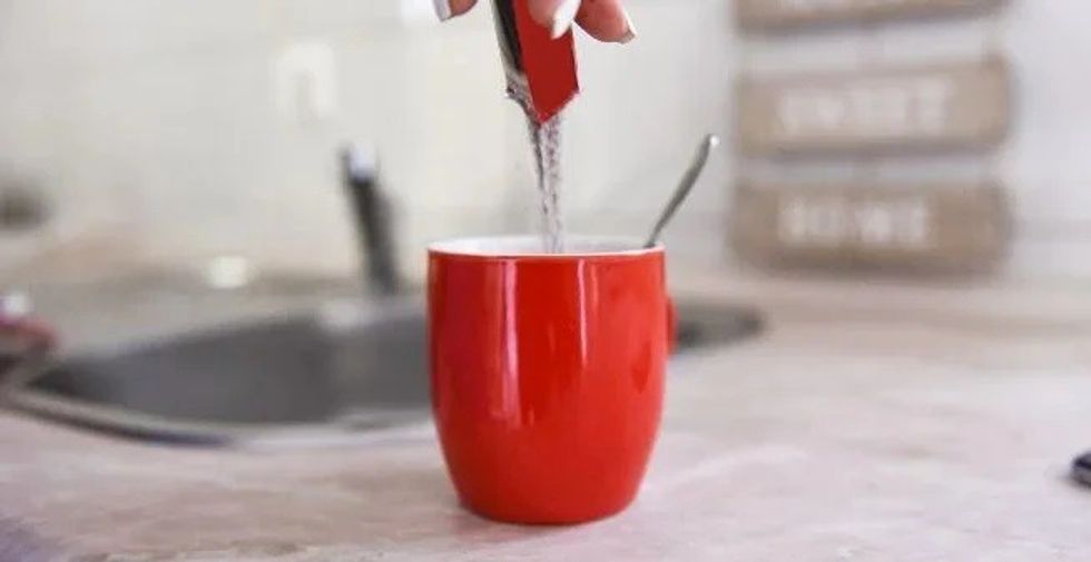 pouring instant coffee in mug desktop