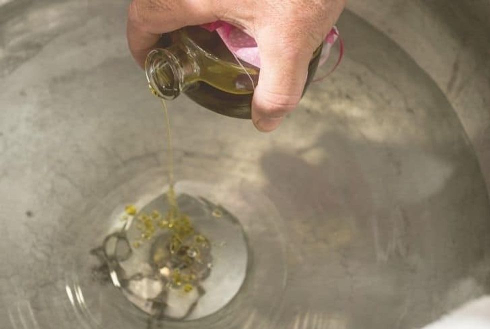 pouring olive oil kitchen sink