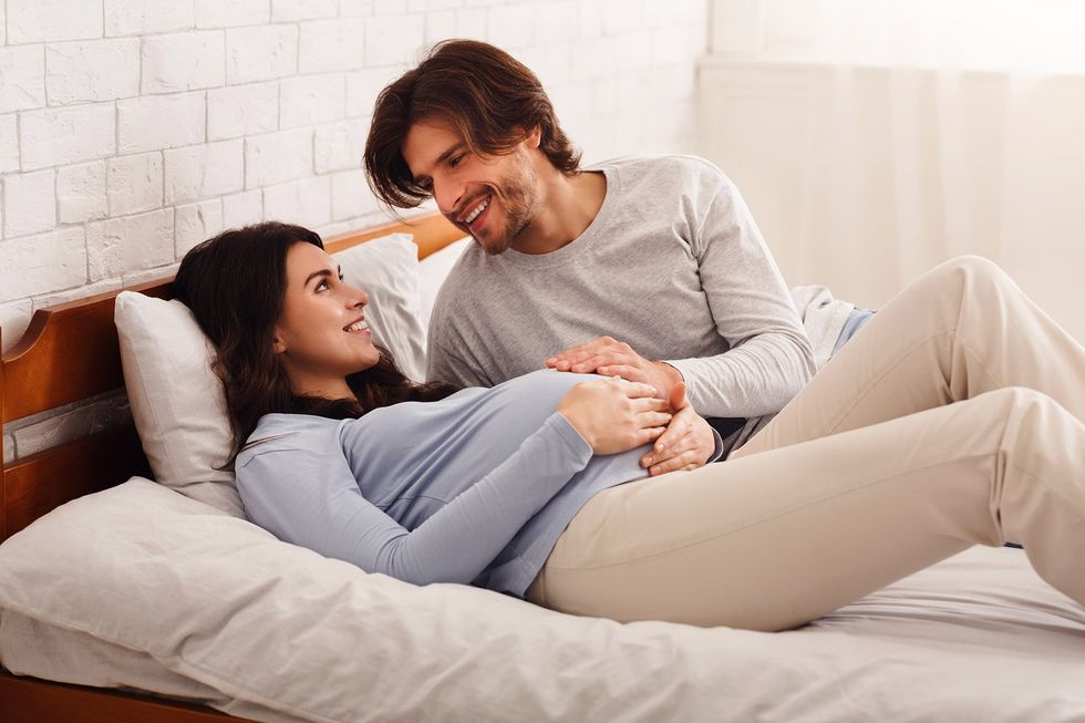 pregnant couple on bed other