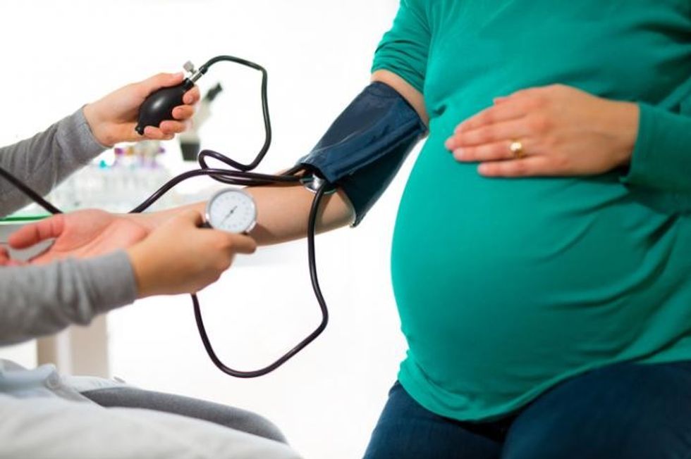 pregnant lady having her blood pressure taken
