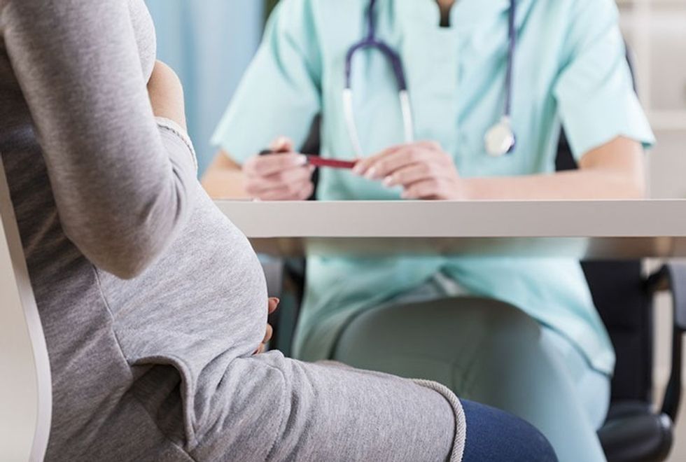 Pregnant woman talking to doctor