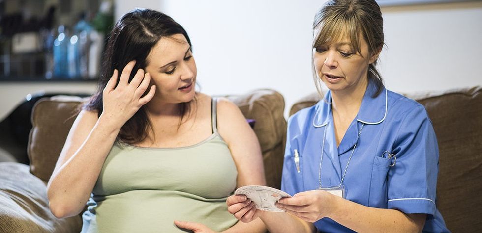 Pregnant woman talking to midwife