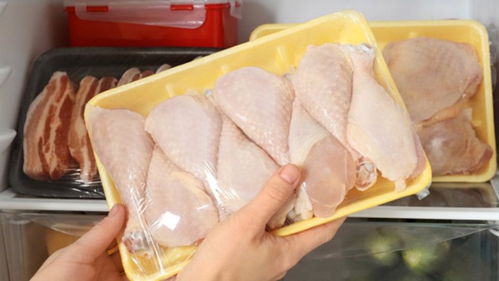 raw chicken in fridge shutterstock 1241670943
