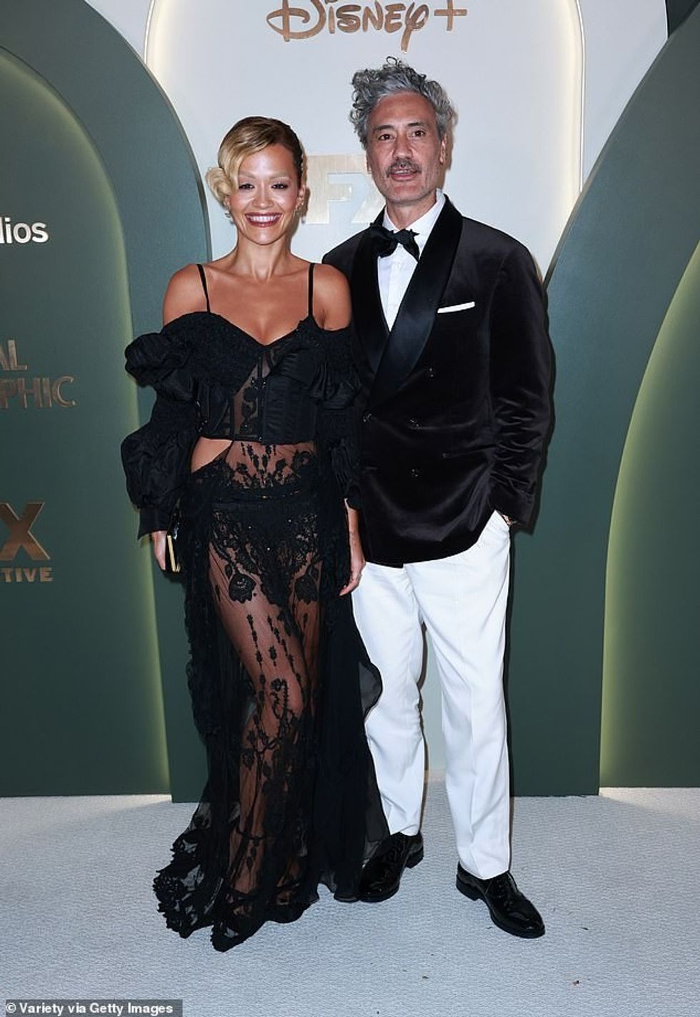 Rita Ora posed up a storm in sheer black lace dress as she beamed beside husband Taika Waititi at the Walt Disney Company bash, held at the Music Center in Los Angeles on Sunday evening