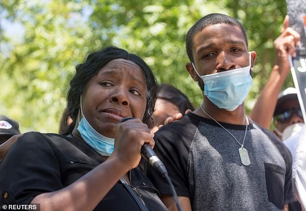 Robert Fuller's sister Diamond Alexander and her husband Jose participate in a protest rally for Fuller after his body was found hanging from a tree on June 10. She has said her brother was ot suicidal and called for the 'truth' about his death in a larger investigation
