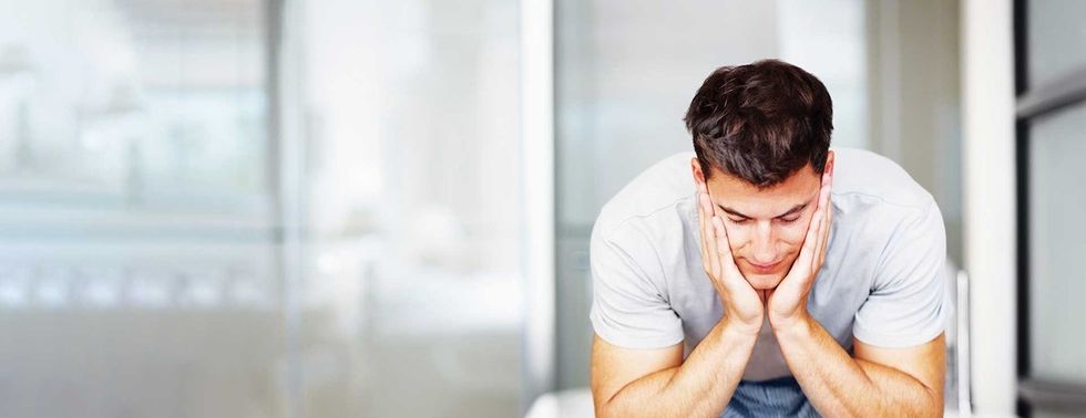 sad man head in hands hero