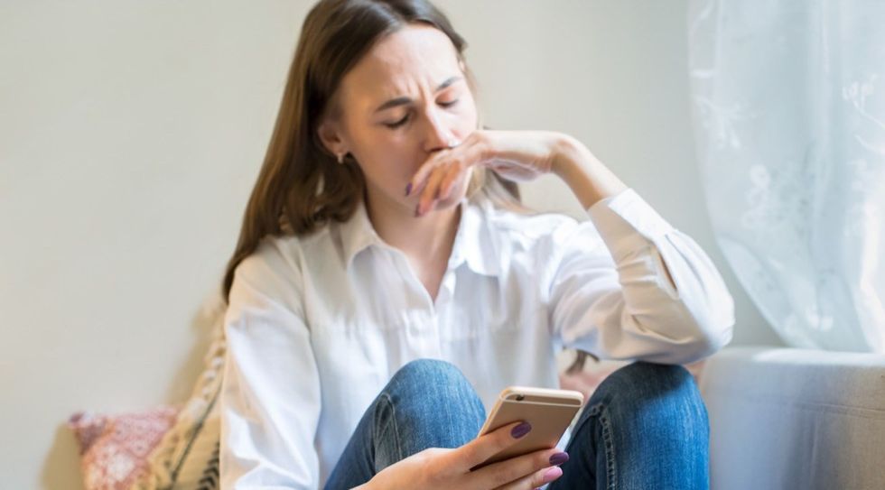Sad Woman Looking at Phone