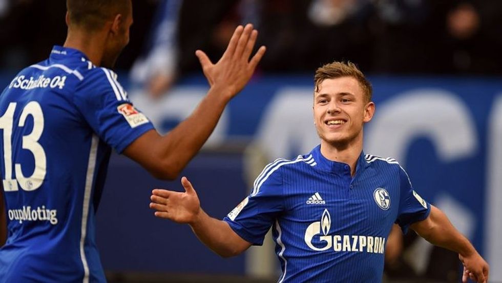 Schalke's midfielder Max Meyer and Schalke's Cameroonian forward Eric Maxim Choupo-Moting celebrate during the German first division Bundesliga football match FC Schalke 04 v 1899 Hoffenheim in Gelsenkirchen, Germany, on March 7, 2015. AFP PHOTO / PATRIK STOLLARZ DFL RULES TO LIMIT THE ONLINE USAGE DURING MATCH TIME TO 15 PICTURES PER MATCH. IMAGE SEQUENCES TO SIMULATE VIDEO IS NOT ALLOWED AT ANY TIME. FOR FURTHER QUERIES PLEASE CONTACT DFL DIRECTLY AT + 49 69 650050. (Photo credit should read PATRIK STOLLARZ/AFP/Getty Images)