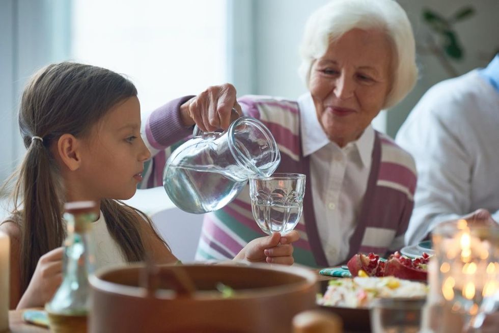 senior woman pouring water from jug