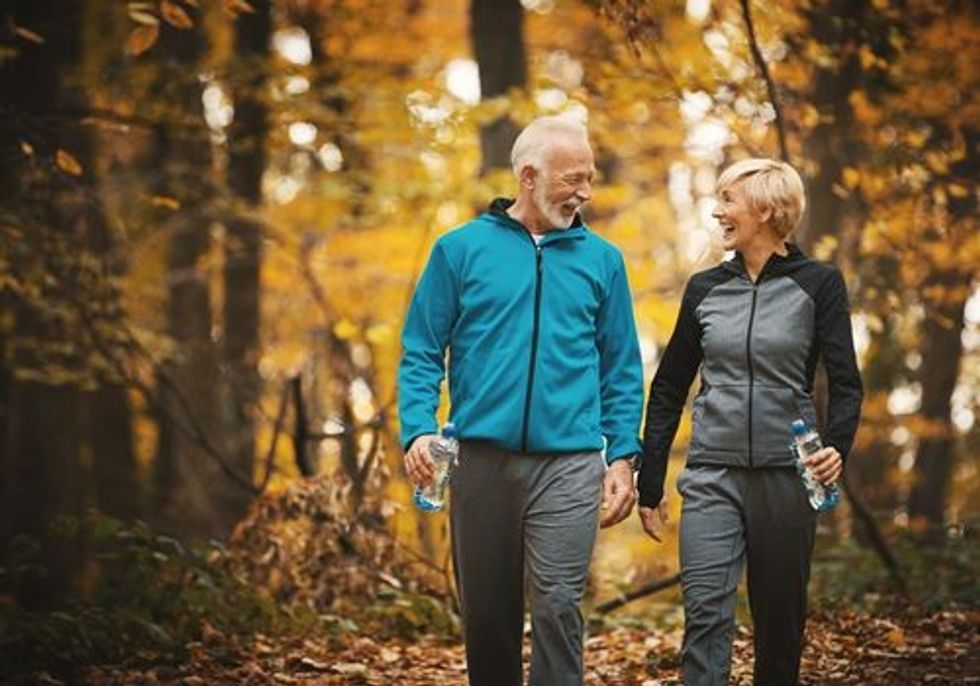 seniorcouplewalkinginautumn f01405d77a974816b9adbcf3333f4f9b