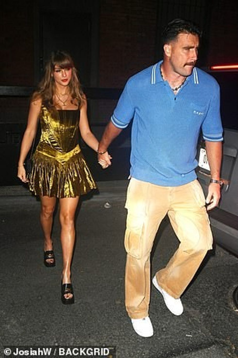 She also carried a black, leather clutch purse with a gold chain from Roberto Cavalli with a hidden detail that many fans claim could be an Easter egg hinting at an upcoming announcement