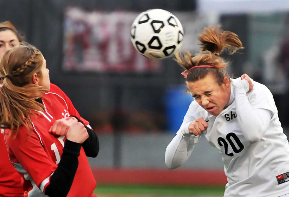 Shen's #20, Sarah Bassett heads ball past Nisky's #15, Schuyler Archambault, left, during girl's soccer semi-finals at Stillwater High School Friday afternoon November 6, 2009. (John Carl D'Annibale / Times Union)