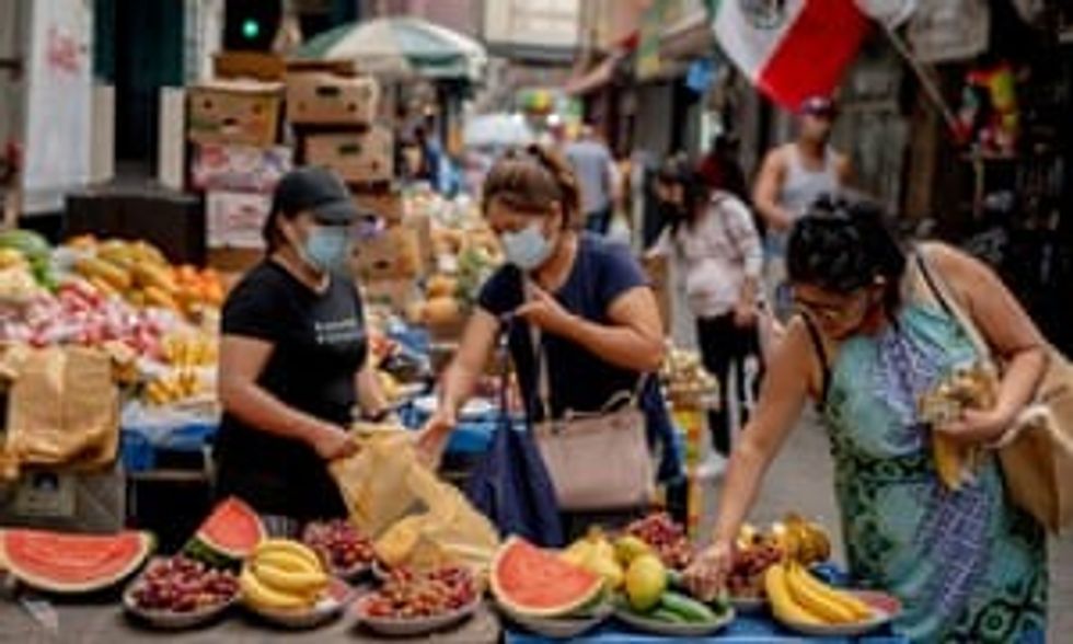 Shoppers in Queens, New York City. The US recorded more than 60,000 new coronavirus cases in six out of nine days to Wednesday.