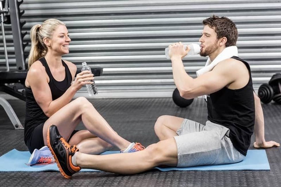 Sporty Fitness Couple drinking postworkout