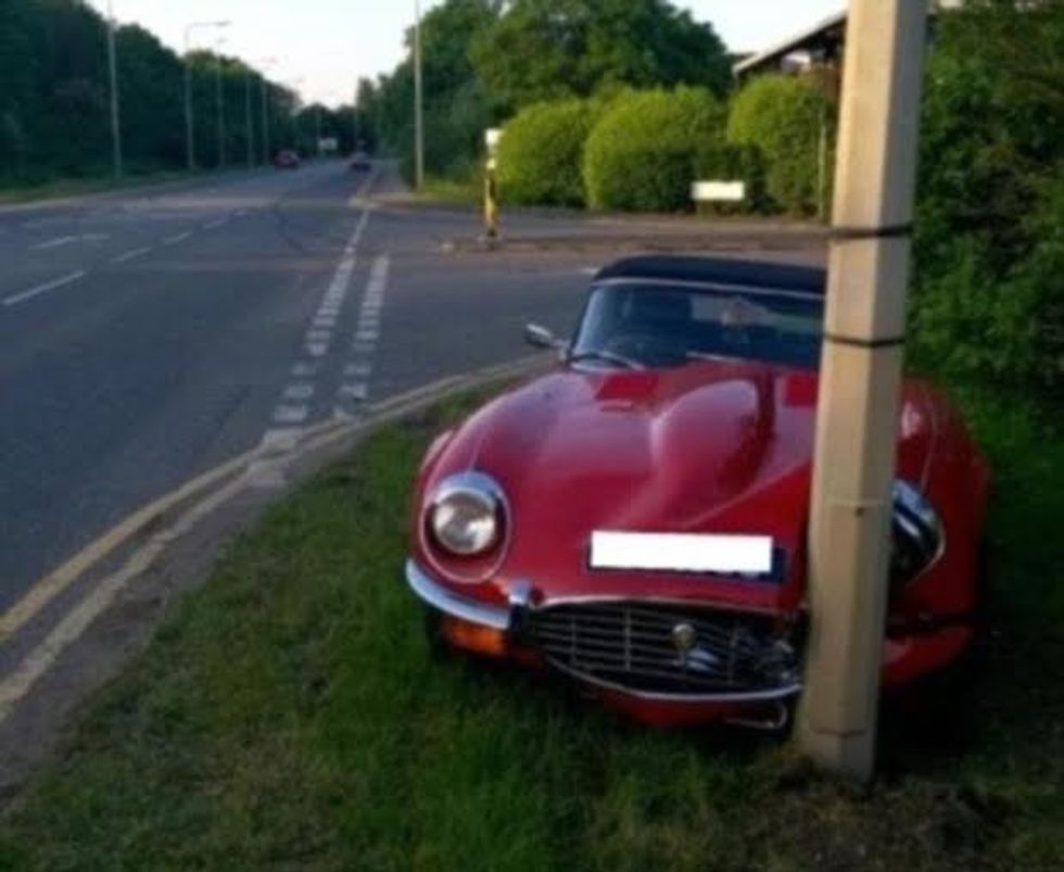 STIAN_E-TYPE JAG CRASH_IMAGE001 THE OWNER of a pristine E-Type Jaguar crashed his beloved car just moments after getting behind the wheel - following years of meticulous work resorting it to its original glory. Police in Cambridge this week revealed photos of the pranged red Jag, often voted the most beautiful car ever made, after the crash in Ely, Cambs, on Monday (June 6). The 1973 Jag came off the road and smashed into a lamppost, crumpling its left headlight and grille - estimated to cost tens of thousands to repair. PC Ali McKenzie, who dealt with the crash, said the car had only been on the road 'briefly' before the crash - but that the owner escaped unscathed. He said: