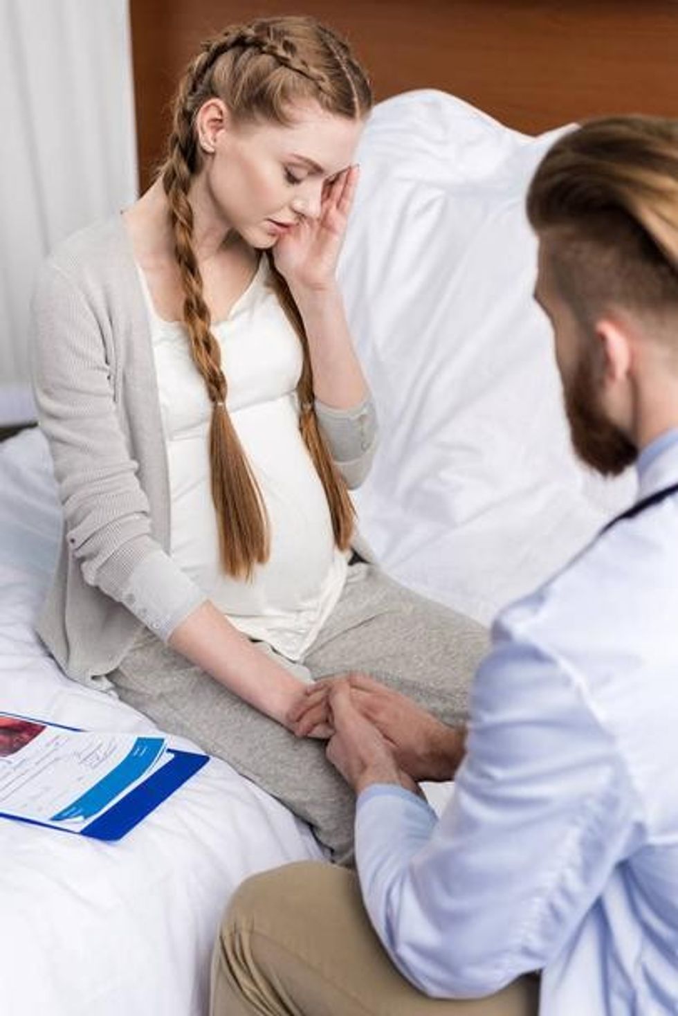 stock photo doctor and upset pregnant woman