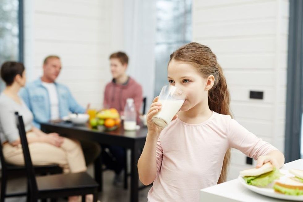 storyblocks healthy girl drinking milk from glass in the kitchen SL u0UrD0 e1567665162833