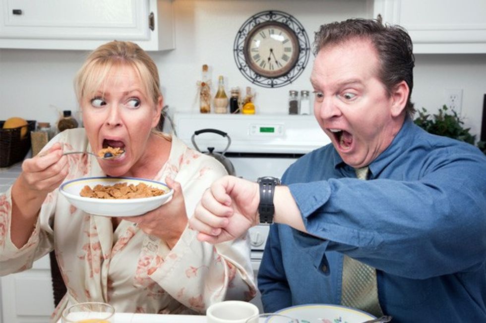 stressed couple rushing to eat breakfast