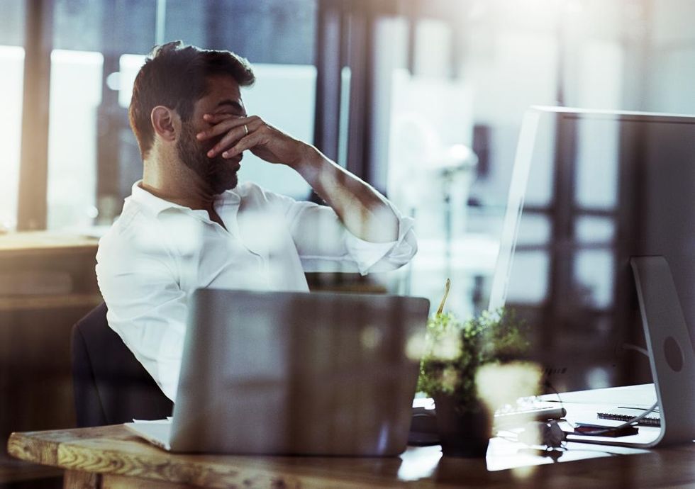stressed man at work wondering about ways to lower cortisol