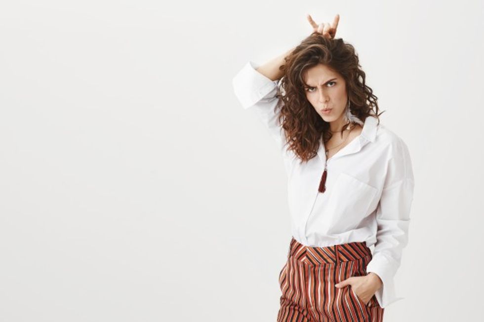 stubborn sassy woman showing devil horns looking determined 176420 19377