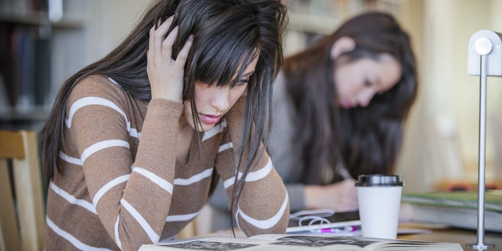 Student working at desk in library