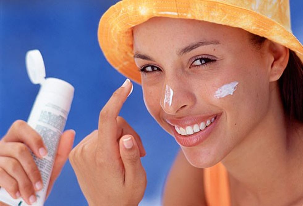 sunscreen woman applying to face