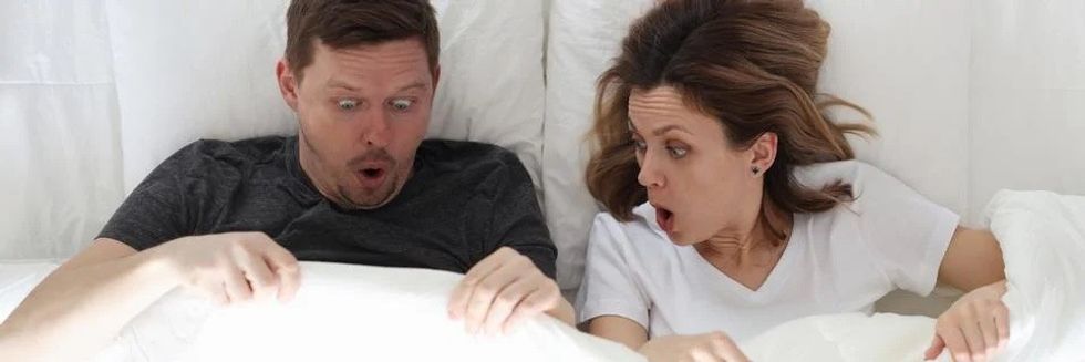 surprised man and woman lying photo