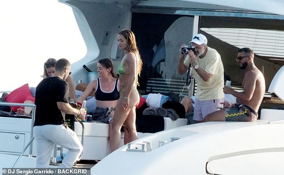 Taika was spotted snapping pictures of Rita as she faced away from the camera looking out at the ocean