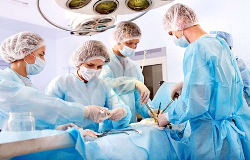 Team surgeon at work in operating room.