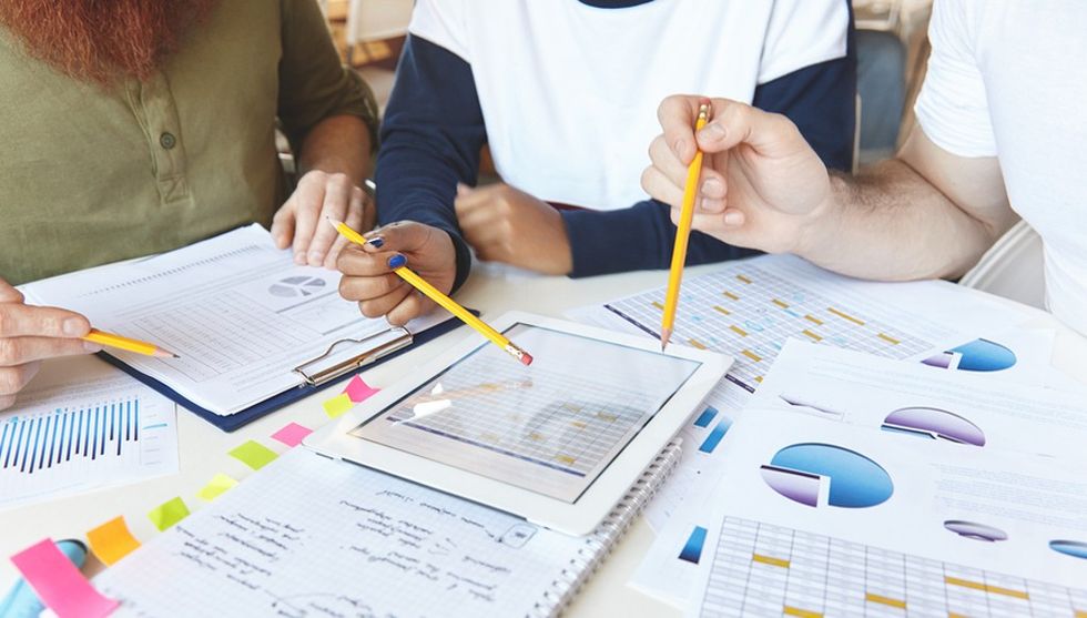 Team working on marketing documents and plans feature image