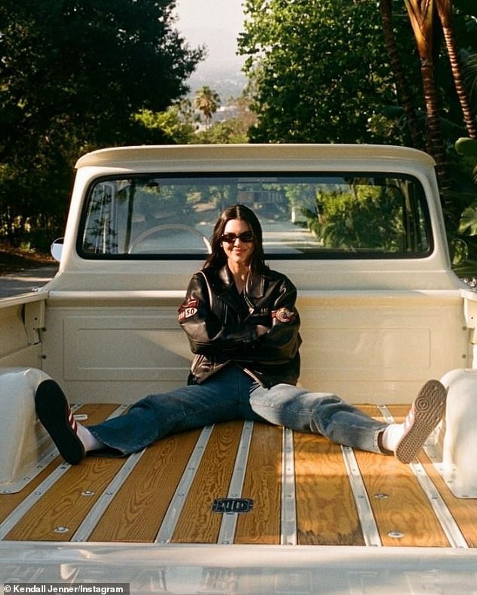 Teamed with the oversize motorcycle jacket from the luxury brand, she wore a classic white tank top and casual, straight-leg jeans